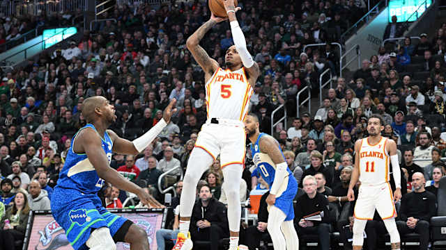 Atlanta Hawks guard Dejounte Murray (5) puts up a shot against Milwaukee Bucks forward Khris Middleton (22) in the second half at Fiserv Forum.